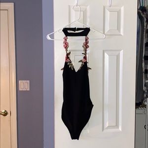 Black bodysuit with roses and has built in choker